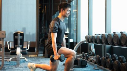 Man holding a lunge with dumbbells