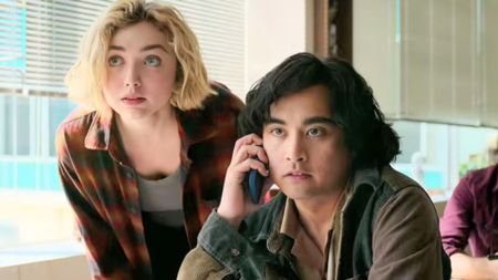 Maddie looks over Simon's shoulder as he talks on the phone