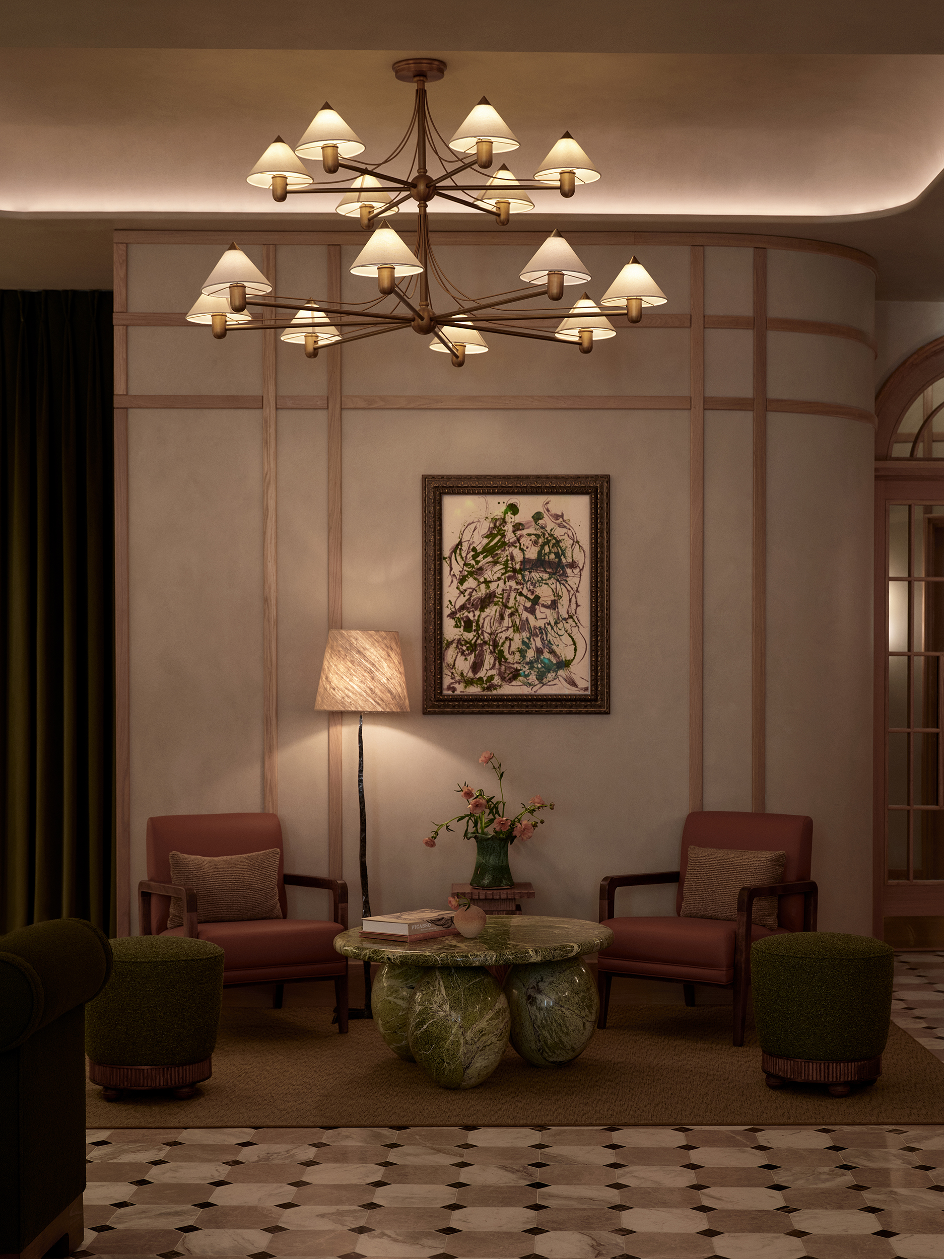 A small seating area with red armchairs, carpeted flooring and a vintage chandelier above