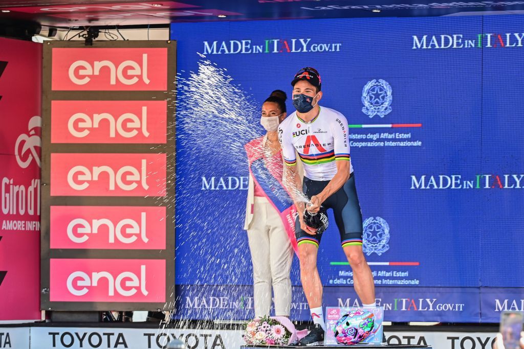 Team Ineos rider Italys Filippo Ganna celebrates on the podium after winning the 21st and last stage of the Giro dItalia 2021 cycling race a 303km individual time trial between Senago and Milan on May 30 2021 Photo by MIGUEL MEDINA AFP Photo by MIGUEL MEDINAAFP via Getty Images