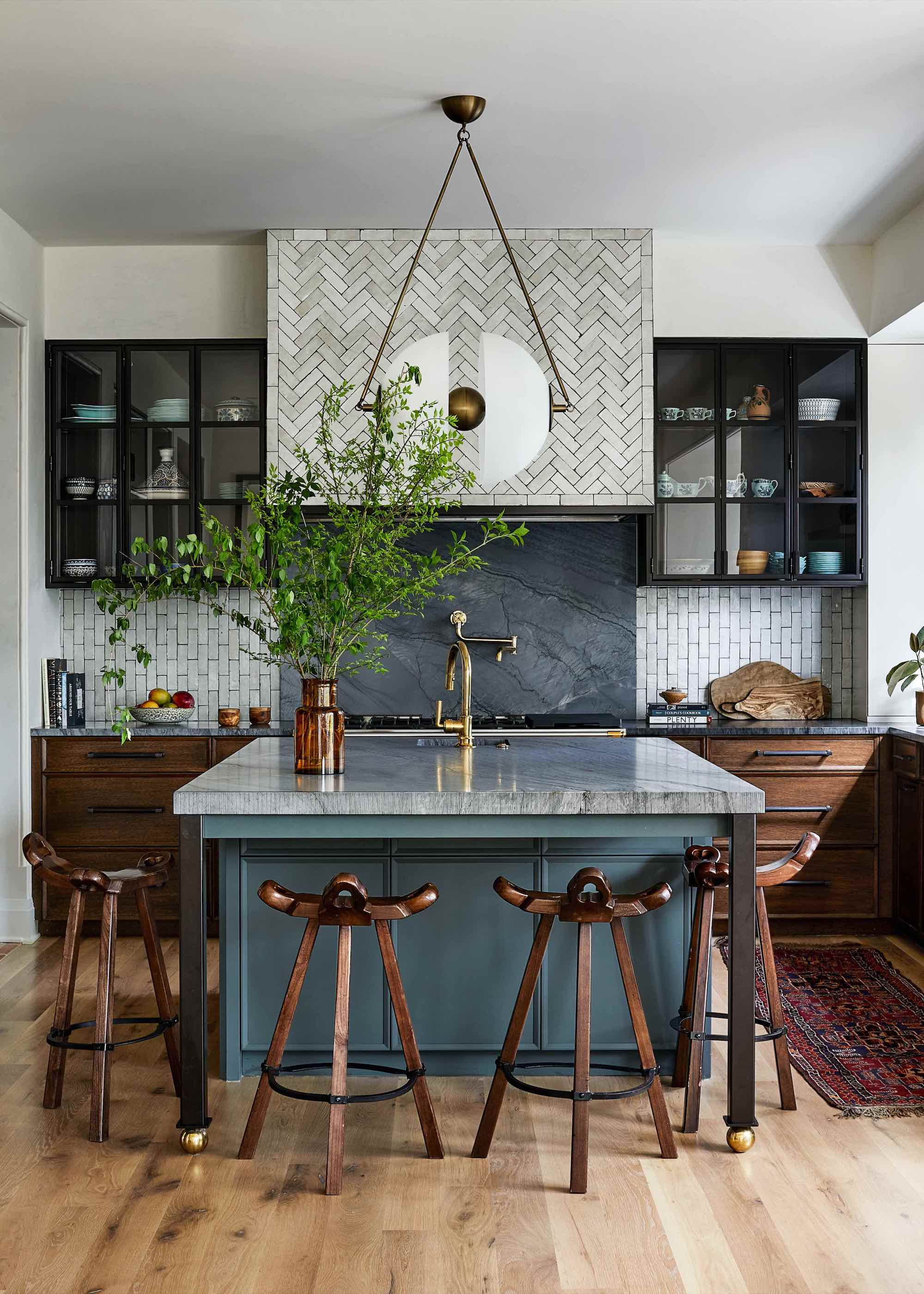 kitchen with blue island, wood cabinets, and a tiled cooker hood