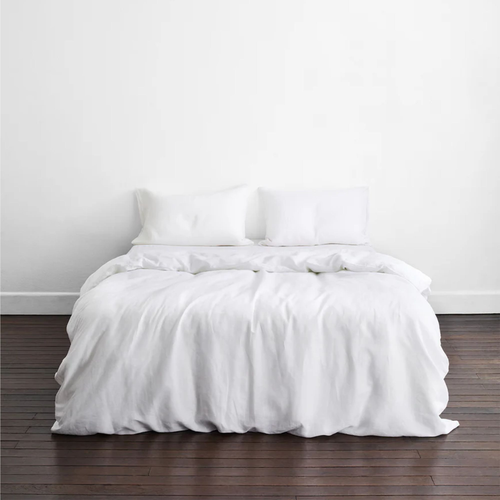 White BedThreads bedding on a double bed in a white bedroom with dark wood polished floors
