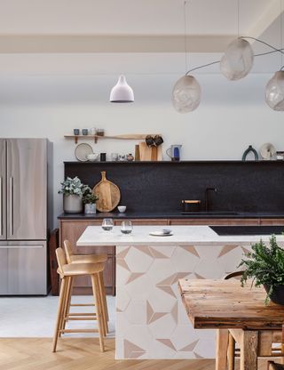 Pink kitchen with blue backsplash and marble countertop