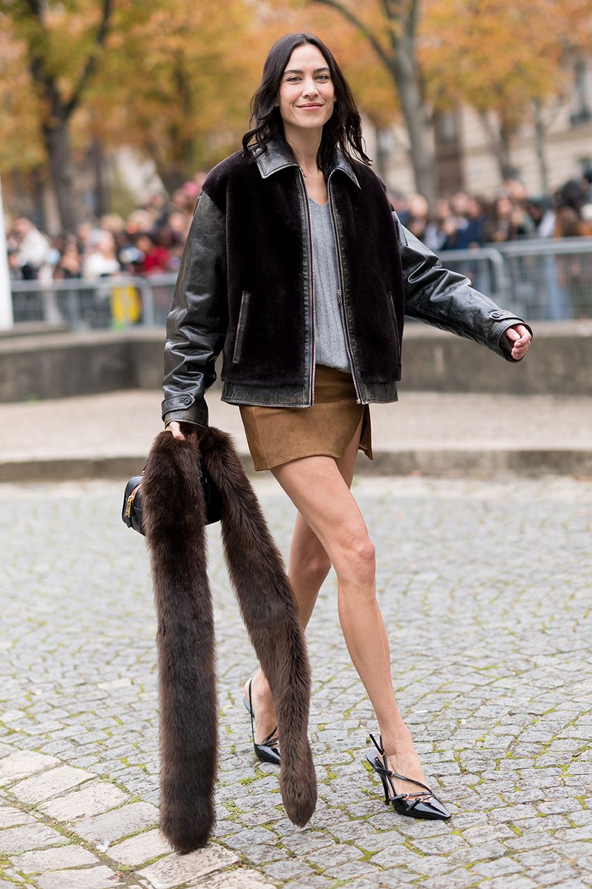 Alexa Chung t the Miu Miu S/S 26 show with a fur scarf