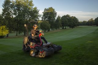 Dan Parker mowing an approach area on a ride-on mower at Edgbaston golf club