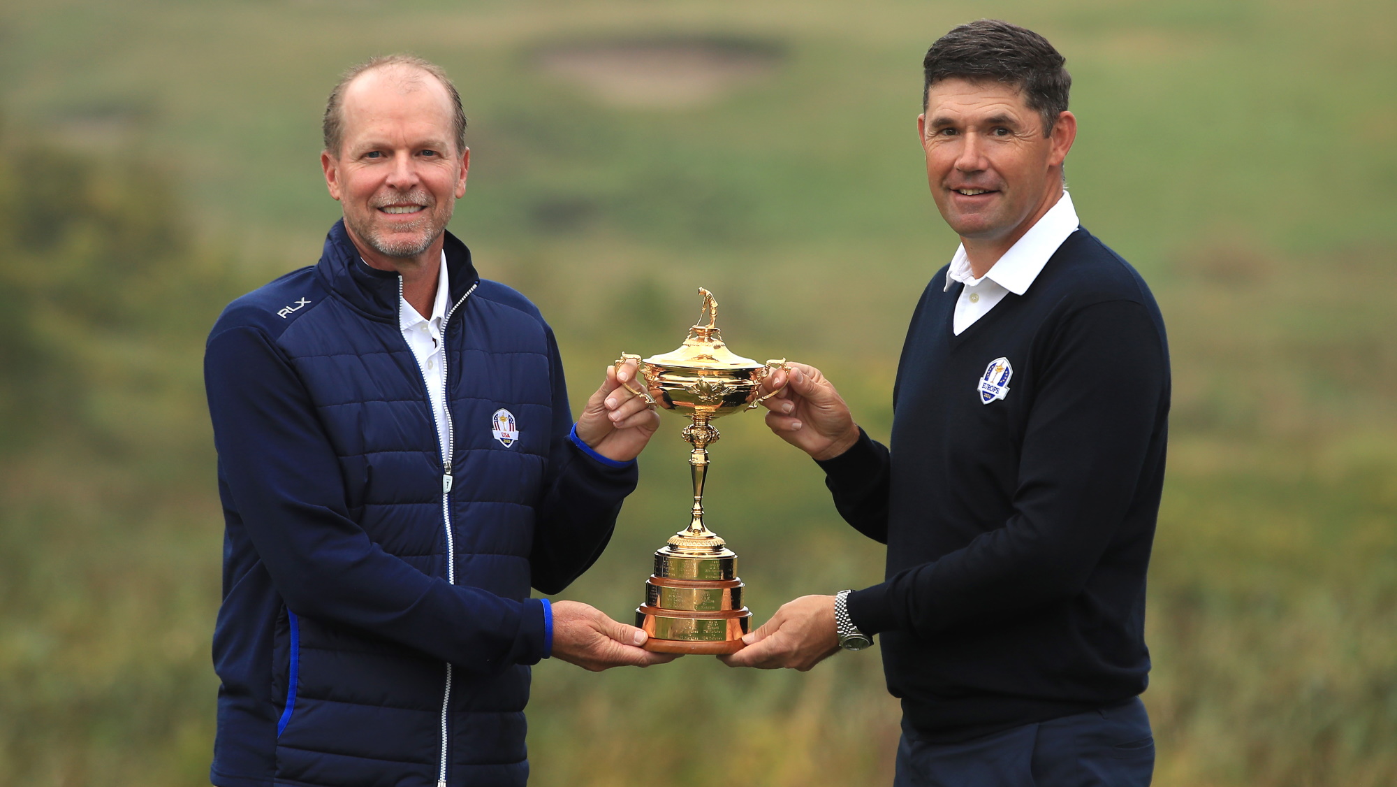 2021 Ryder Cup captains Steve Stricker and Padraig Harrington posing with the trophy