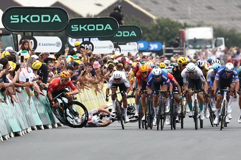 UnoX Pro Cycling Team&#039;s Soren Waerenskjold (left) crashes as the pack of riders sprint to the stage 4 finish line during the 2023 Tour de France