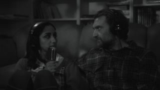 a woman speaks into a mike while looking at a man wearing headphones in a black and white still from the movie didn't die