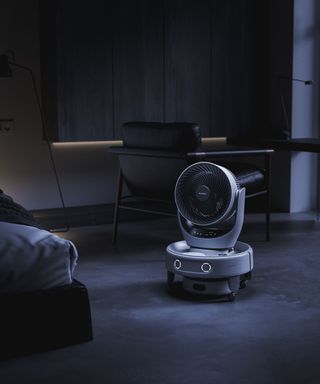 SwitchBot K20+Pro robot vacuum with fan in dark bedroom