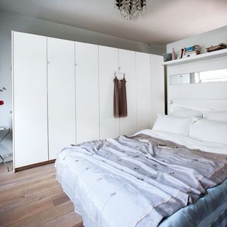 bedroom with white walls and wooden flooring