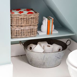 toilet stash with wooden basket and toilet papers