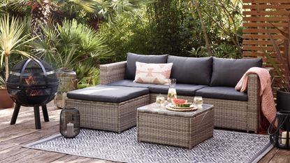 decking with Dobbies sofa, outdoor rug and fire pit