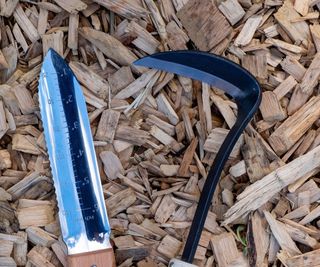 Pruning sickle and hori hori knife in a garden