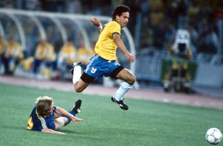 Brazil's Careca leaps over Sweden's Stefan Schwarz at the 1990 World Cup.