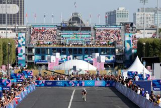 PARIS FRANCE AUGUST 04 Kristen Faulkner of Team United States sprints at finish line as Gold medal winner during the Womens Road Race on day nine of the Olympic Games Paris 2024 at Trocadero on August 04 2024 in Paris France Photo by Tim de WaeleGetty Images