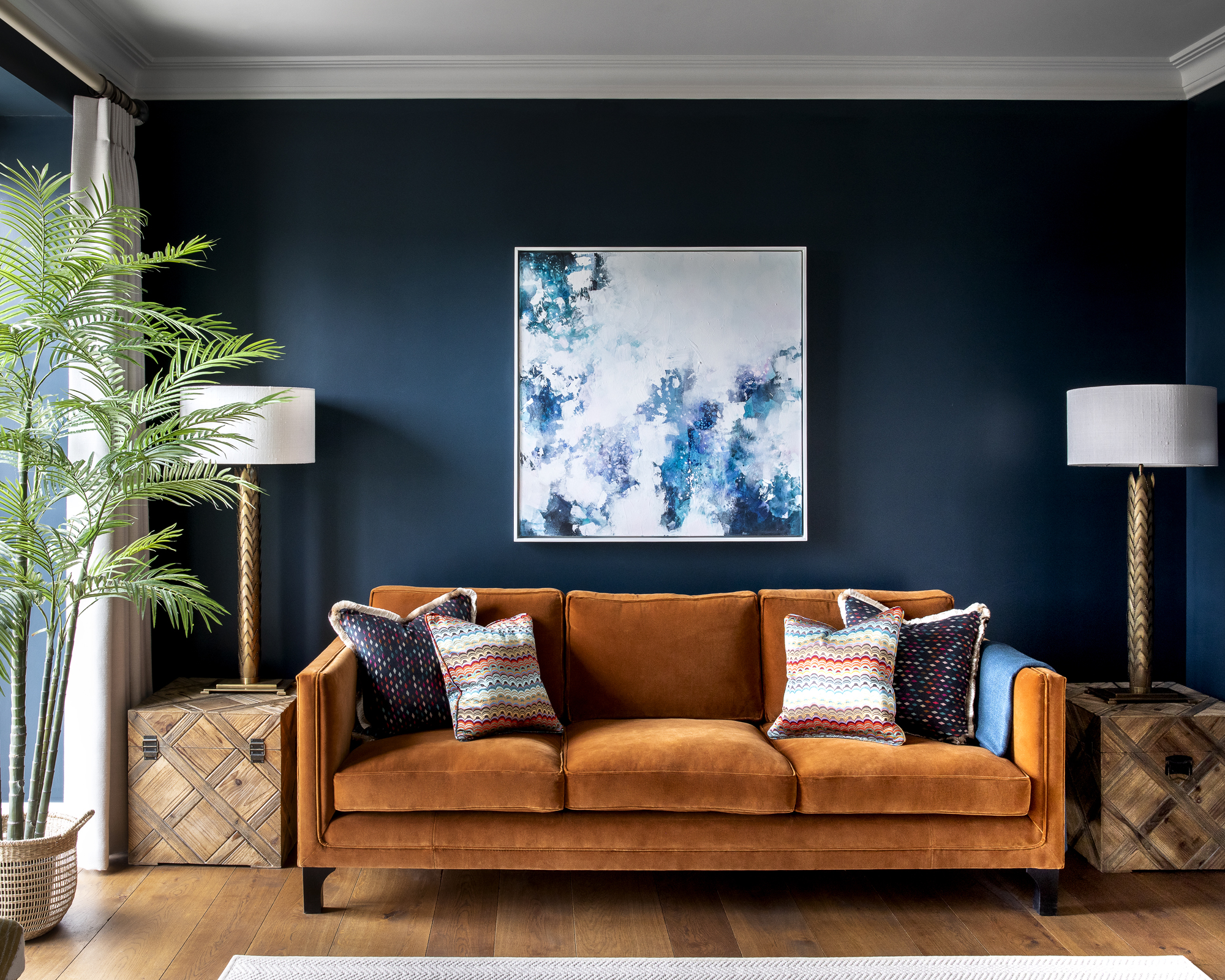 A living room with brown sofa idea with dark blue walls and brown ochre sofa