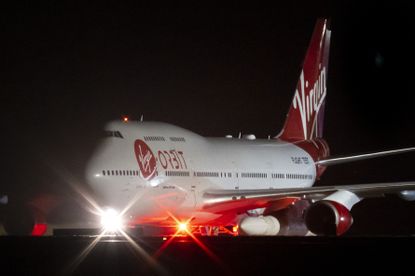 A Boeing 747 aircraft carrying the LauncherOne rocket 