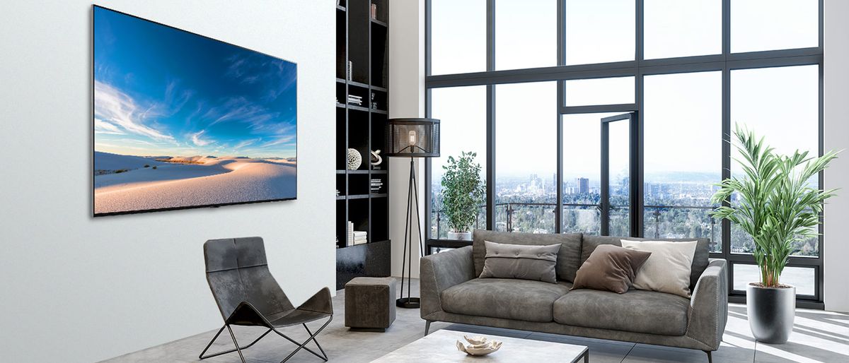 LG QNED MiniLED 99 Series 8K TV hanging on wall in living room