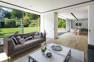 light and modern living room with oversized doors in open plan layout