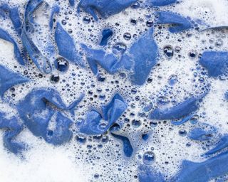Jeans in soapy water in close-focus