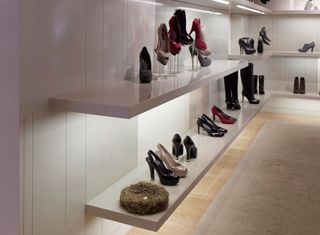 exhibition with shoes on shelf and golden egg