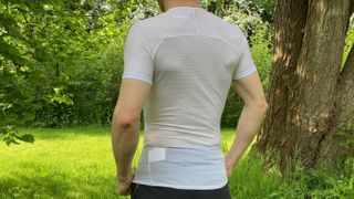 Man wearing white summer base layer T-shirt outside