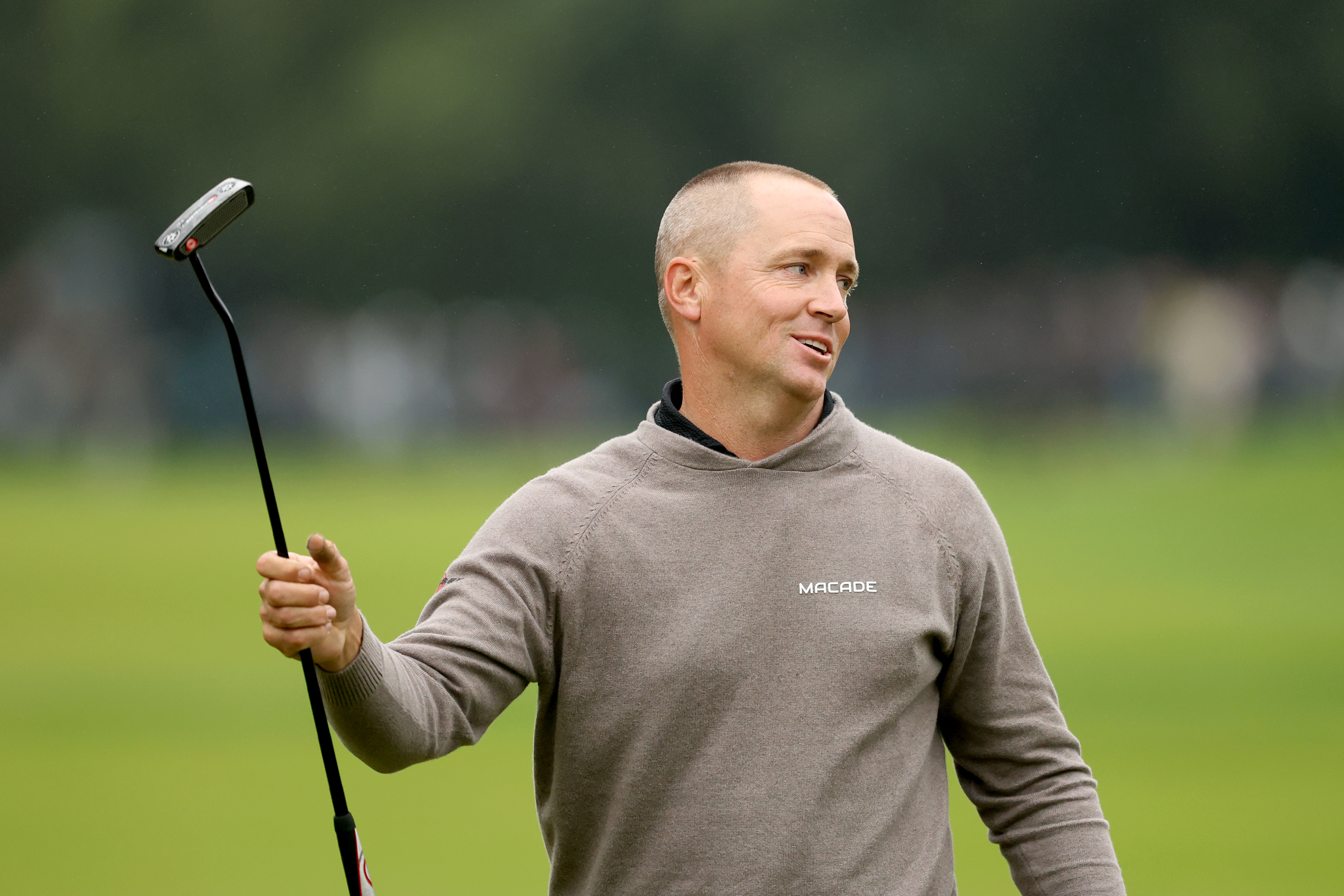 Alex Noren celebrates as he walks off the green