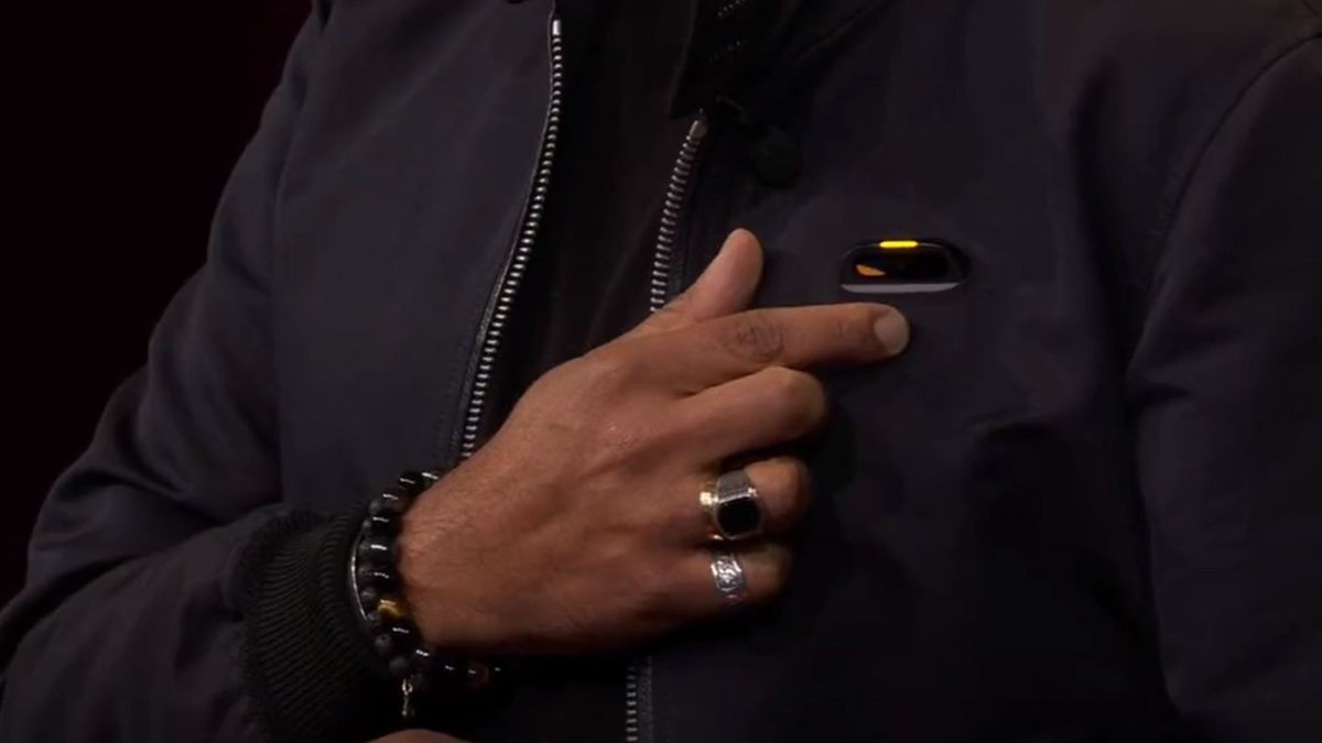 Imran Chaudhri&#039;s hand pressing a button the the Humane device in his breast pocket