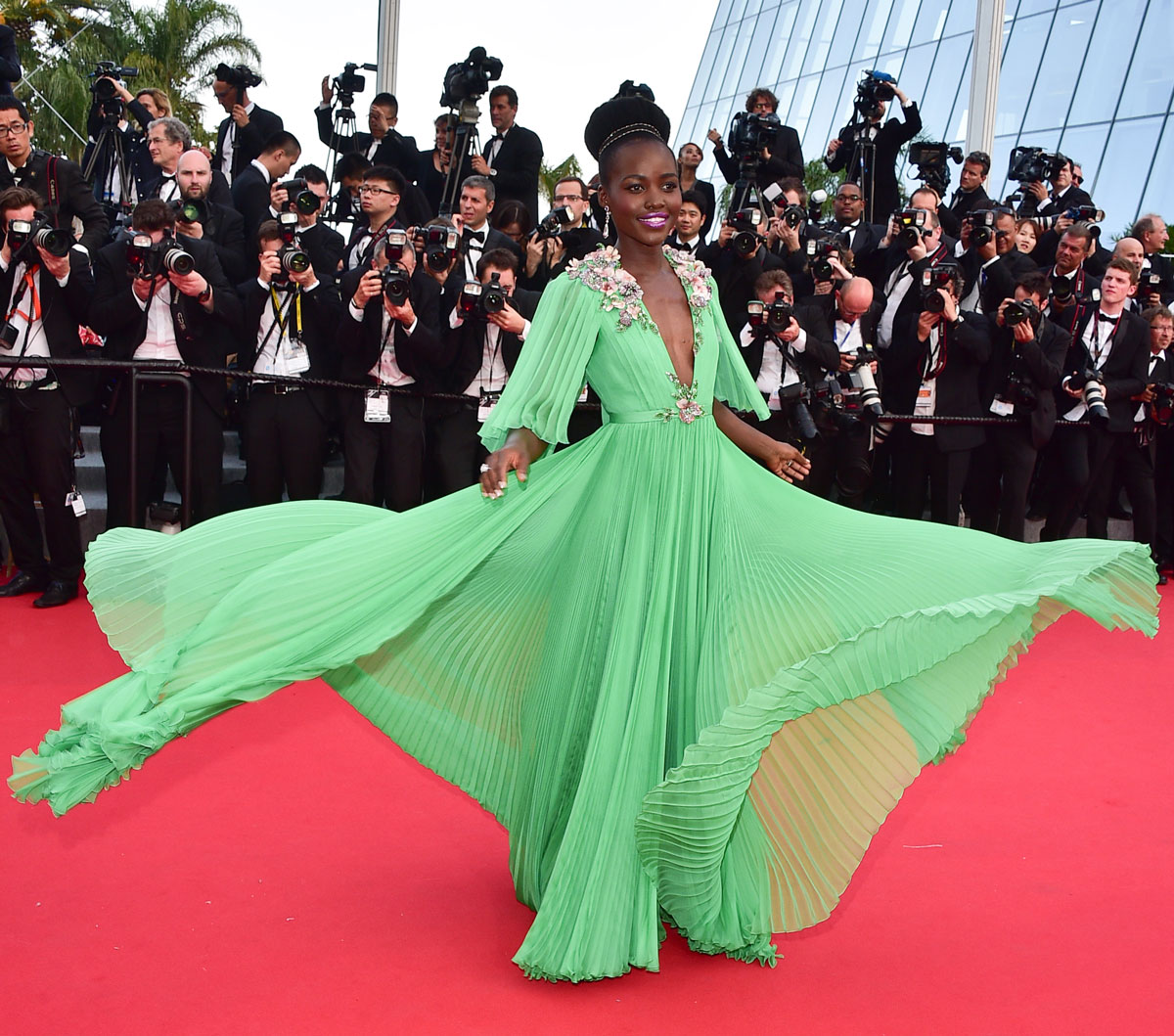 lupita nyong'o twirls in a green pleated gown at the cannes film festival