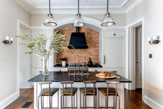 Rustic white kitchen with brick splashback