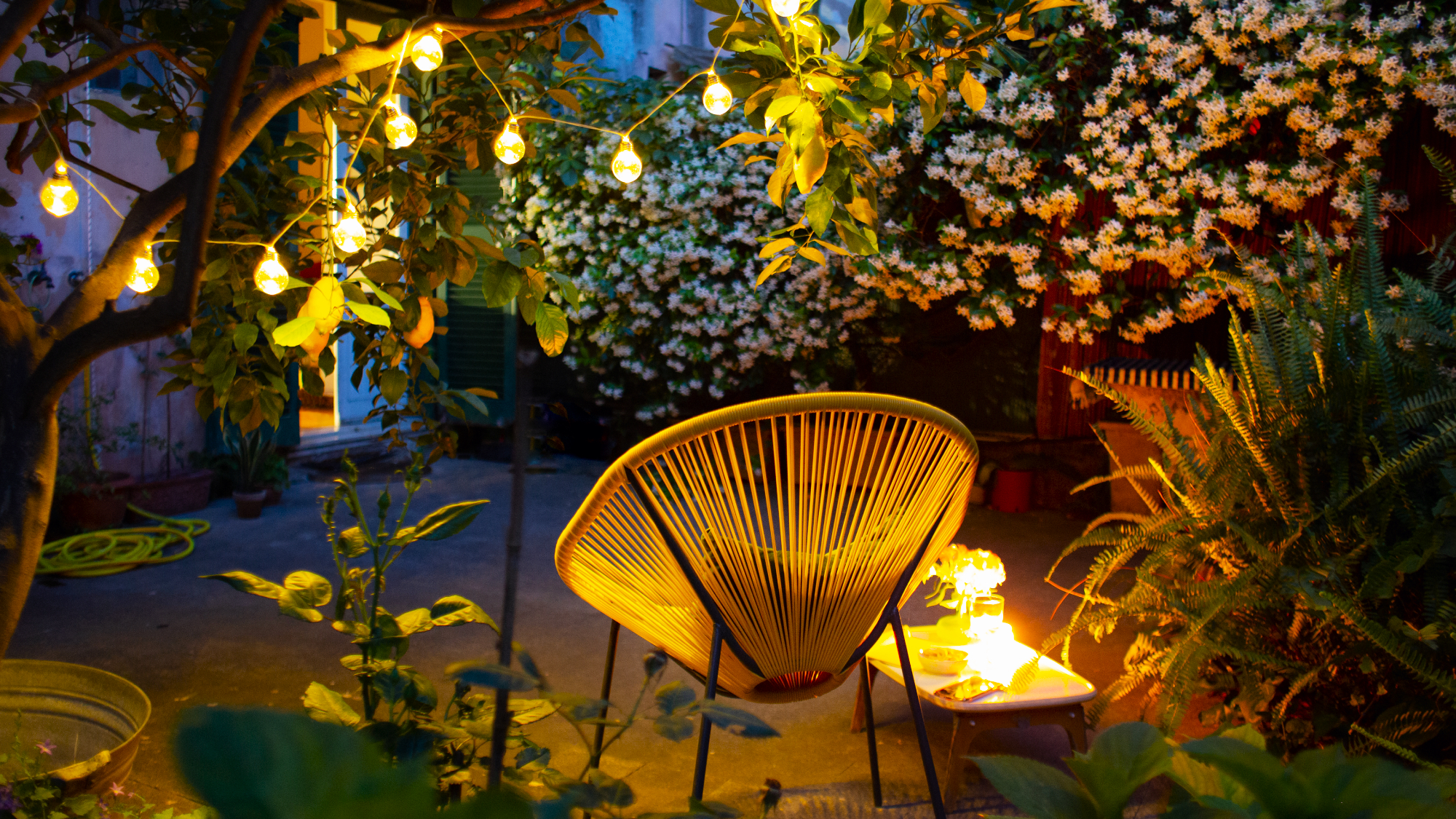 solar garden lighting with string lights and a patio chair