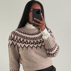 @nlmarilyn wearing a turtleneck sweater underneath a crewneck sweater.