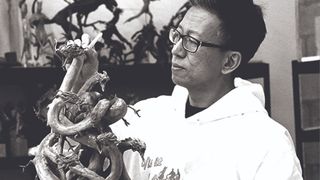 First impressions, artist Simon Lee holds a model of a creature