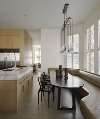 Banquette seating in modern kitchen with wood cabinets