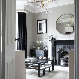 Monochrome sitting room with art deco and eastern influences and fireplace