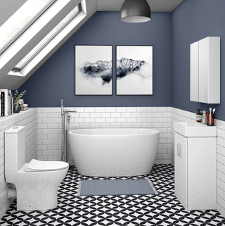 small bathroom suite with small bath, monochrome patterned tiles and blue walls