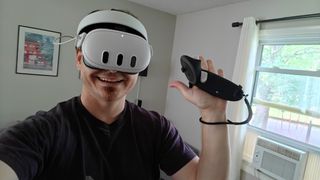Wearing a Meta Quest 3 headset and holding a controller with the Kiwi Design G4 Max grips on it