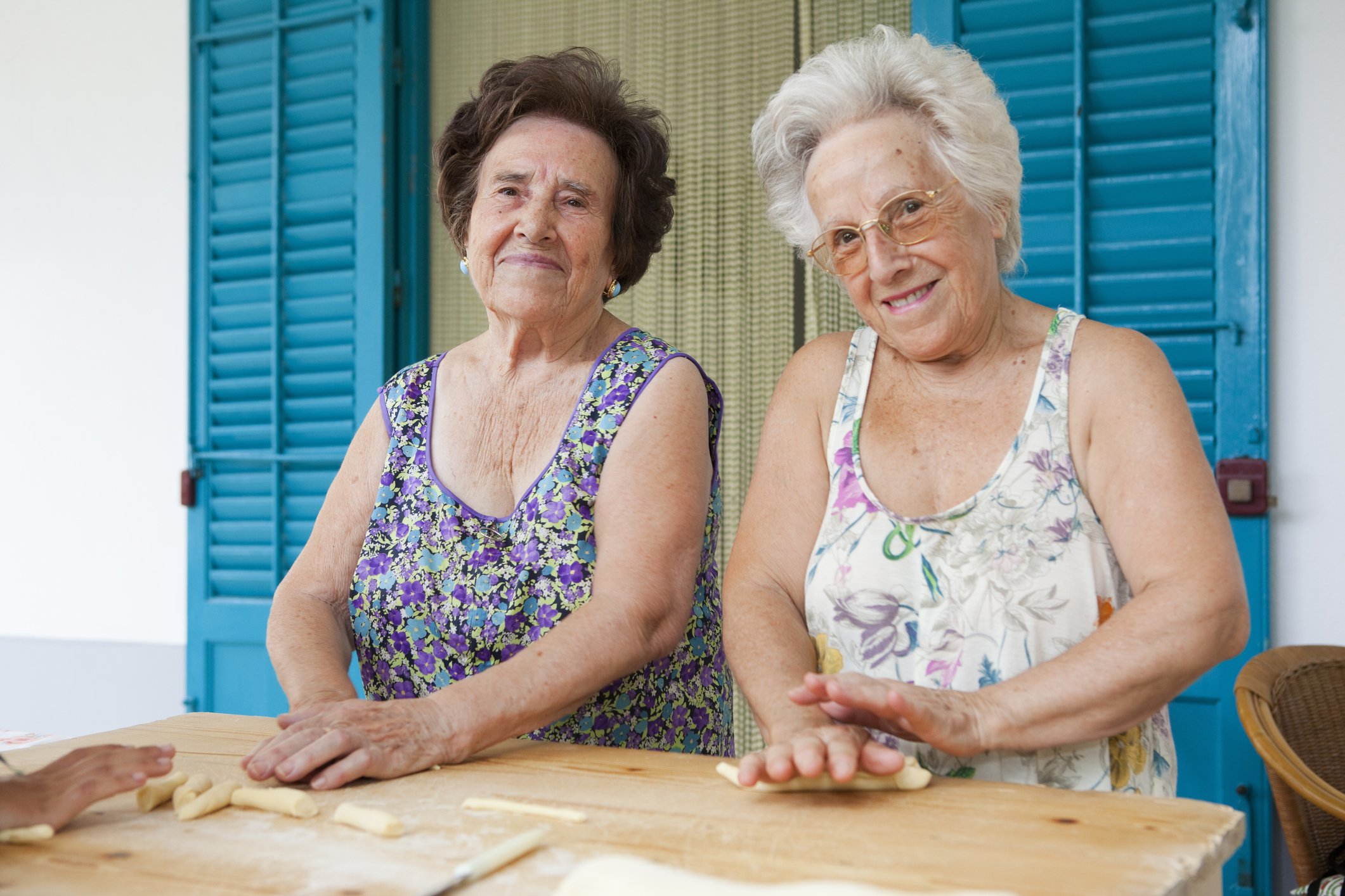 Older women making pasta together in Italy.