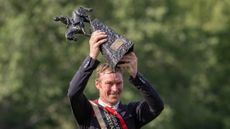 William Whitaker holds up the Boomerang trophy