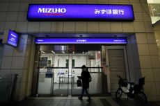 A customer enters a branch of Mizuho Bank