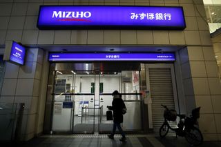 A customer enters a branch of Mizuho Bank