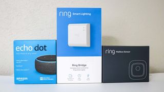 A picture of the Ring Mailbox Sensor, Ring Bridge and an Echo Dot