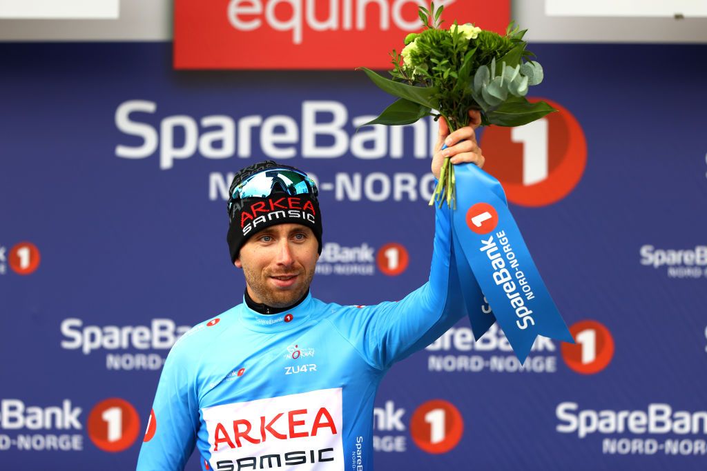 BRONNOYSUND NORWAY AUGUST 12 Amaury Capiot of Belgium and Team Arka Samsic celebrates at podium as Blue Points Jersey winner during the 9th Arctic Race Of Norway 2022 Stage 2 a 1543km stage from Mosjen to Brnnysund ArcticRace on August 12 2022 in Bronnoysund Norway Photo by Michael SteeleGetty Images