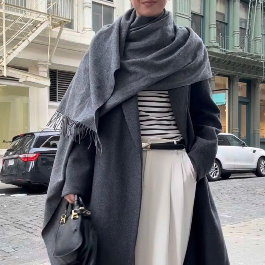 Jessica Habich Thomas wears a gray wrap coat in Soho New York City
