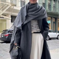 Jessica Habich Thomas wears a gray wrap coat in Soho New York City