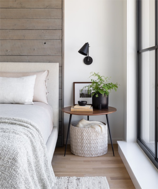a modern bedroom with a timber paneled wall