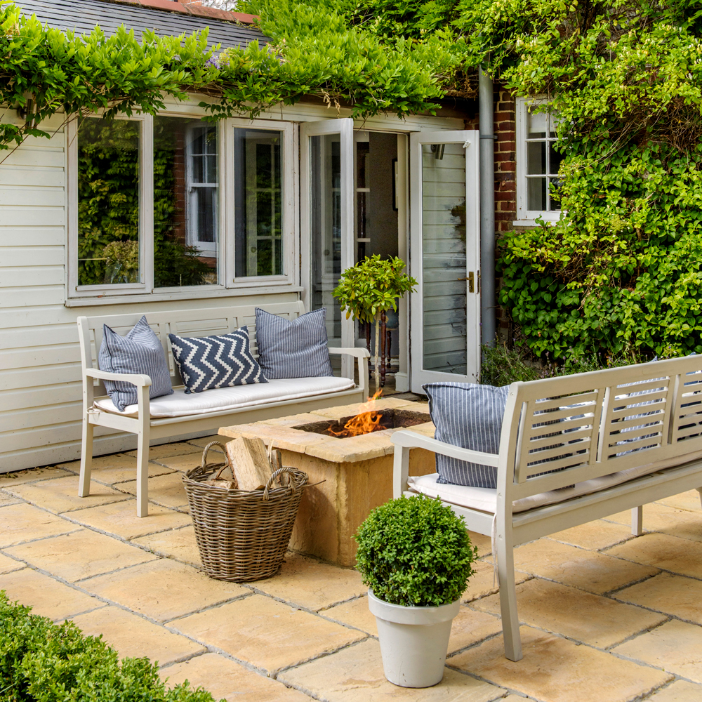 patio area with white bench and cushions