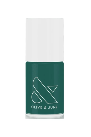 A bottle of Olive & June jade green nail polish against a white background.