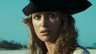 Keira Knightley with pirates hat on looking to the right while outside in Pirates of the Caribbean: Dead Man's Chest