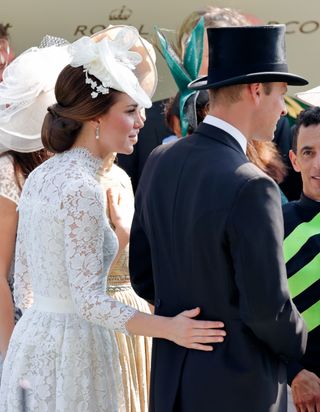 Kate Middleton touches the small of Prince William's back